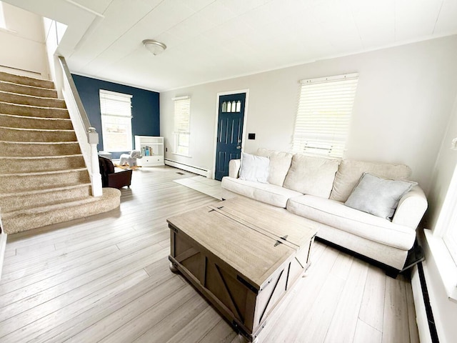 313 E Auburn Ave, Bellefontaine, OH 43311 - living room featuring a baseboard heating unit, stairs, and wood finished floors