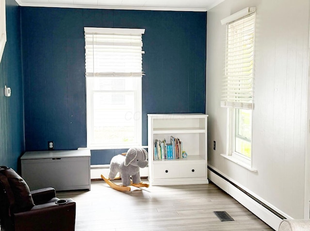 313 E Auburn Ave, Bellefontaine, OH 43311 - recreation room featuring a baseboard heating unit and wood finished floors