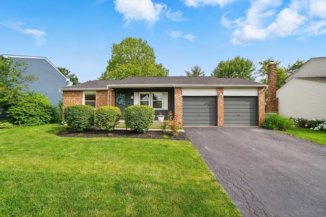 2216 Smoky View Blvd, Powell, OH 43065 - view of front of home with an attached garage, asphalt driveway, brick siding, and a front yard