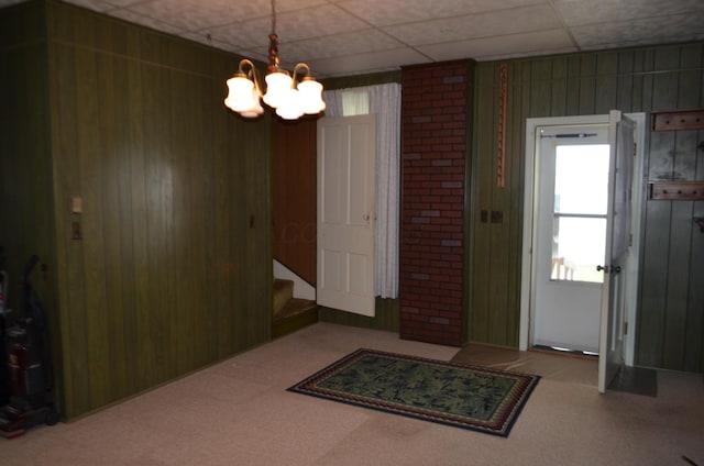 5810 Bickle Church Rd NW, Pickerington, OH 43147 - carpeted foyer entrance with a chandelier, wooden walls, and stairway