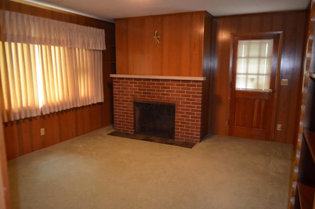 5810 Bickle Church Rd NW, Pickerington, OH 43147 - unfurnished living room featuring carpet floors, wood walls, plenty of natural light, and a brick fireplace