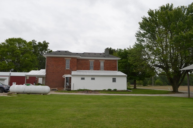 5810 Bickle Church Rd NW, Pickerington, OH 43147 - rear view of house with a lawn, a chimney, and brick siding