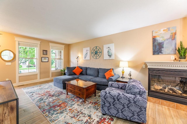 3750 Echo Pl, Powell, OH 43065 - living area featuring wood finished floors, a glass covered fireplace, and baseboards
