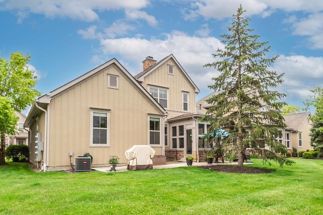 3750 Echo Pl, Powell, OH 43065 - back of house featuring cooling unit, a sunroom, a chimney, and a yard