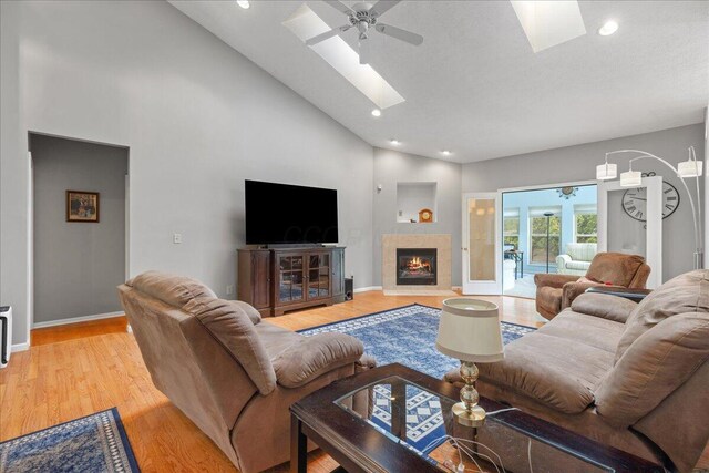 2880 Longridge Way, Grove City, OH 43123 - living area featuring a skylight, high vaulted ceiling, light wood-type flooring, a ceiling fan, and baseboards