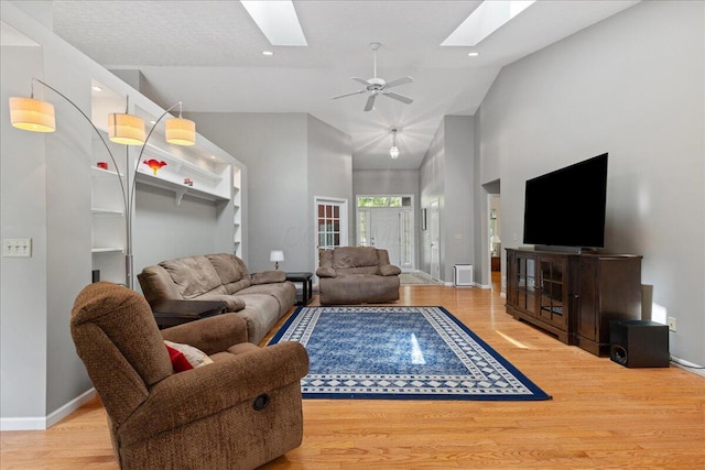2880 Longridge Way, Grove City, OH 43123 - living room featuring a skylight, wood finished floors, high vaulted ceiling, baseboards, and a ceiling fan