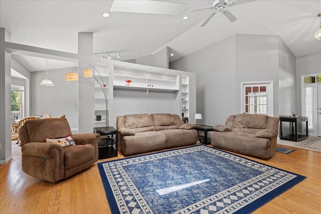 2880 Longridge Way, Grove City, OH 43123 - living room featuring ceiling fan, wood finished floors, a textured ceiling, high vaulted ceiling, and a skylight