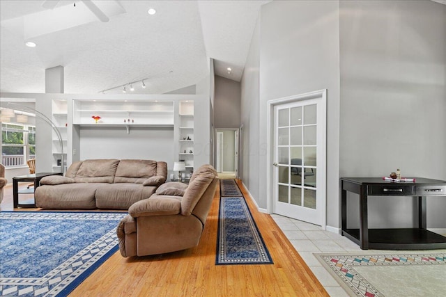 2880 Longridge Way, Grove City, OH 43123 - living room with wood finished floors, arched walkways, vaulted ceiling, ceiling fan, and a textured ceiling