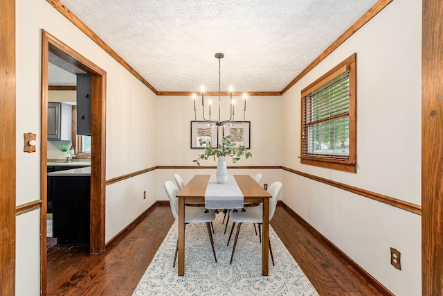 6392 Hilltop Ave, Reynoldsburg, OH 43068 - dining room featuring dark wood-type flooring, a chandelier, ornamental molding, a textured ceiling, and baseboards