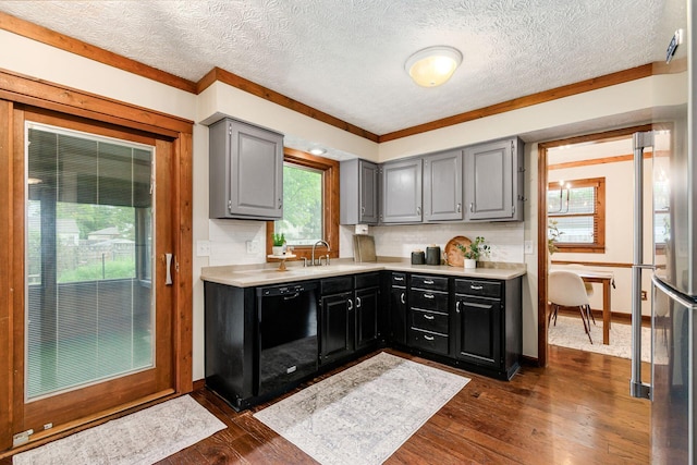 6392 Hilltop Ave, Reynoldsburg, OH 43068 - kitchen with black dishwasher, light countertops, gray cabinetry, tasteful backsplash, and dark wood finished floors