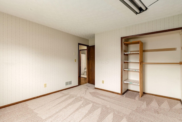 6392 Hilltop Ave, Reynoldsburg, OH 43068 - unfurnished bedroom featuring carpet floors, a textured ceiling, baseboards, and a closet