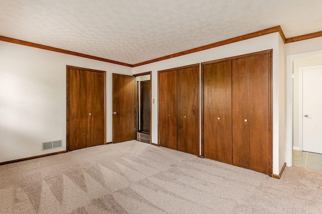 6392 Hilltop Ave, Reynoldsburg, OH 43068 - unfurnished bedroom with carpet floors, two closets, ornamental molding, and baseboards