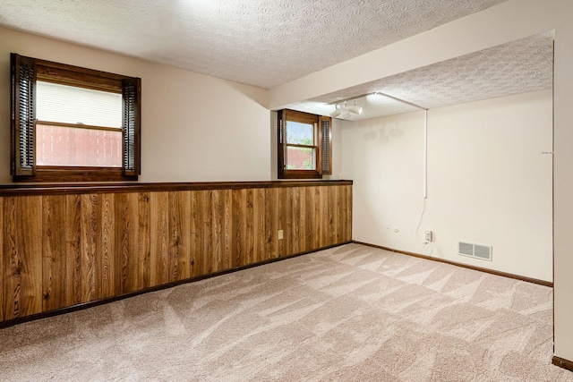 6392 Hilltop Ave, Reynoldsburg, OH 43068 - carpeted spare room with a textured ceiling, track lighting, and baseboards