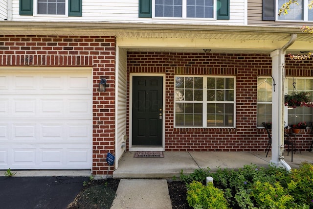 642 Grove Cir Unit 1902, Columbus, OH 43230 - view of exterior entry featuring brick siding and an attached garage