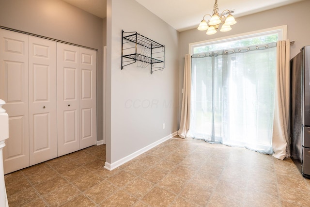 642 Grove Cir Unit 1902, Columbus, OH 43230 - unfurnished dining area featuring a chandelier and baseboards