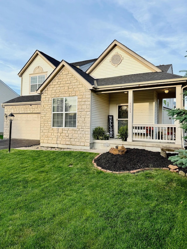 1522 E Quail Run Dr, Newark, OH 43055 - view of front facade with an attached garage, stone siding, a front lawn, a porch, and roof with shingles