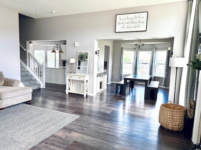 1522 E Quail Run Dr, Newark, OH 43055 - living room with a chandelier, healthy amount of natural light, stairs, and dark wood finished floors