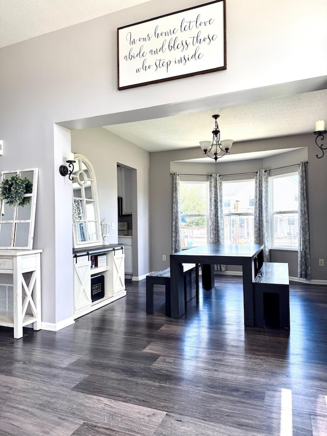 1522 E Quail Run Dr, Newark, OH 43055 - dining space featuring dark wood-style floors, a chandelier, and baseboards