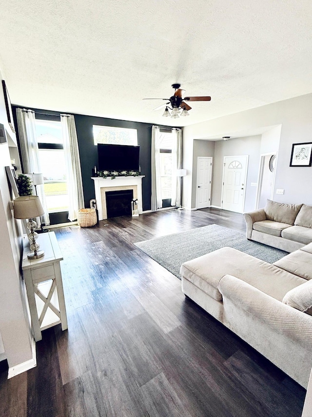 1522 E Quail Run Dr, Newark, OH 43055 - living room with a ceiling fan, a fireplace, plenty of natural light, a textured ceiling, and dark wood-type flooring