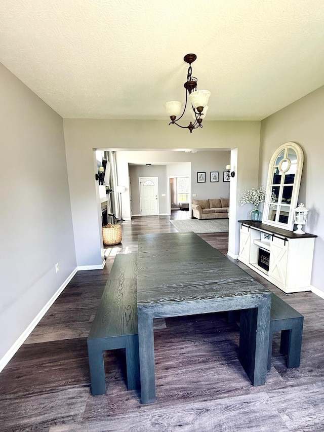1522 E Quail Run Dr, Newark, OH 43055 - unfurnished dining area featuring baseboards, wood finished floors, and a chandelier