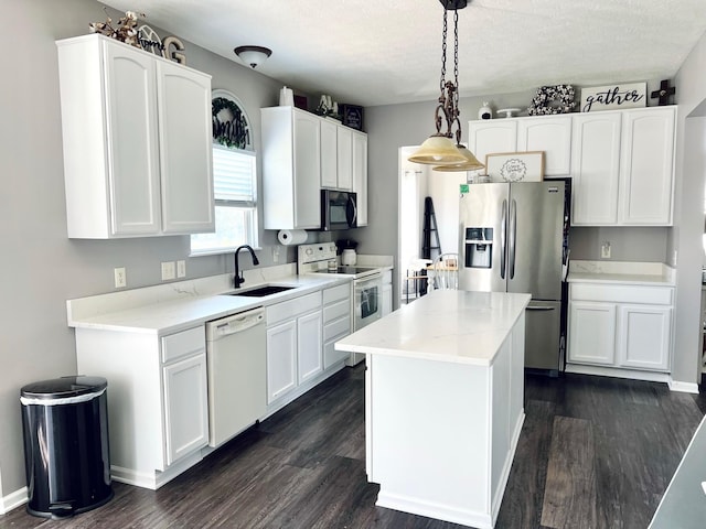 1522 E Quail Run Dr, Newark, OH 43055 - kitchen featuring white appliances, a sink, white cabinets, dark wood-style flooring, and a textured ceiling
