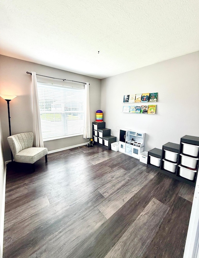 1522 E Quail Run Dr, Newark, OH 43055 - sitting room featuring wood finished floors, a textured ceiling, and baseboards