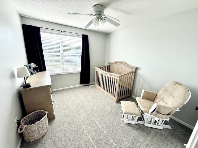 1522 E Quail Run Dr, Newark, OH 43055 - carpeted bedroom with a textured ceiling, baseboards, a nursery area, and ceiling fan