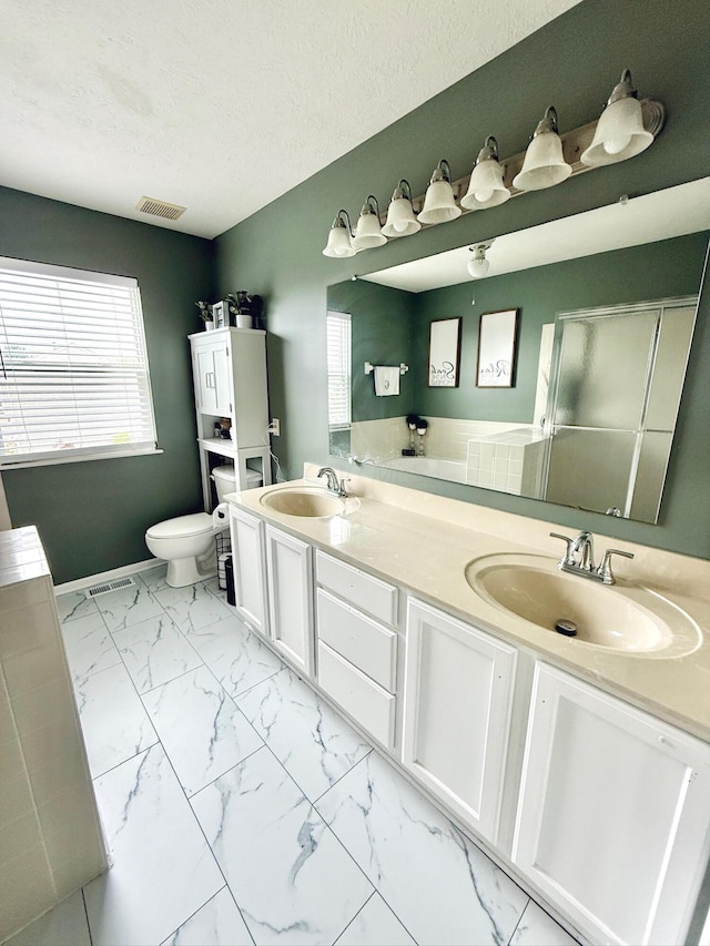 1522 E Quail Run Dr, Newark, OH 43055 - full bath featuring double vanity, toilet, a shower stall, marble finish flooring, and a textured ceiling