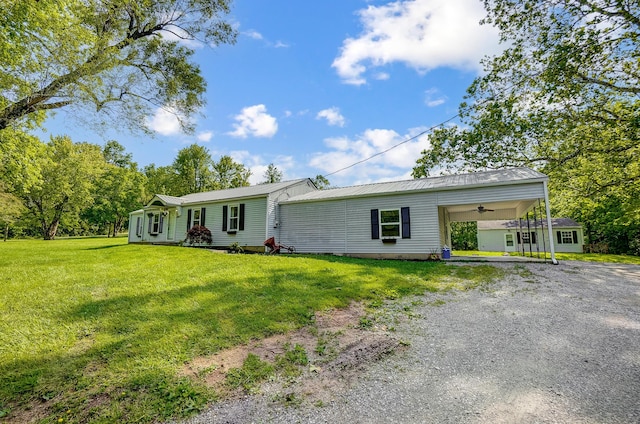 1036 State Route 247, Hillsboro, OH 45133 - view of front facade with a front yard, driveway, a carport, a ceiling fan, and a metal roof