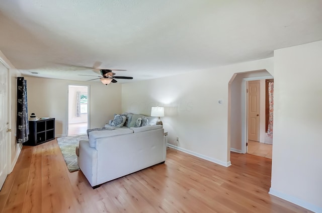 1036 State Route 247, Hillsboro, OH 45133 - living area with arched walkways, ceiling fan, and light wood-type flooring