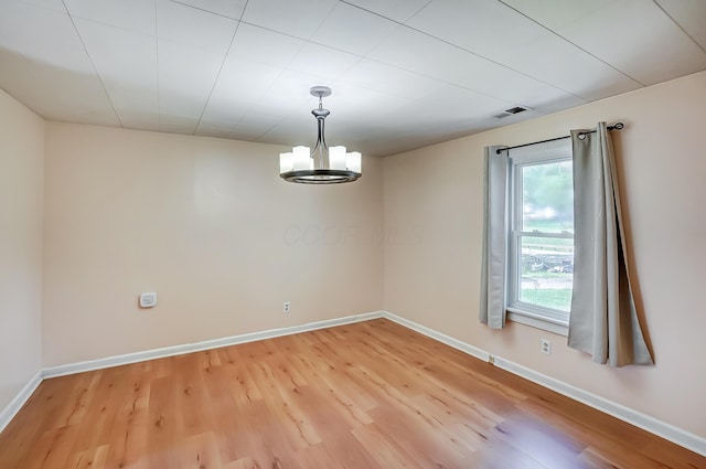 1036 State Route 247, Hillsboro, OH 45133 - unfurnished room featuring light wood-style flooring and a chandelier