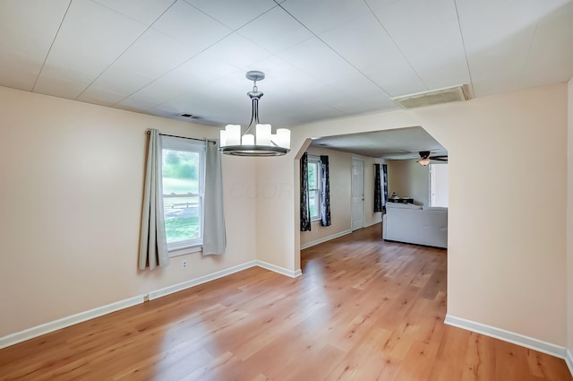 1036 State Route 247, Hillsboro, OH 45133 - unfurnished dining area with light wood-type flooring, a chandelier, and a ceiling fan