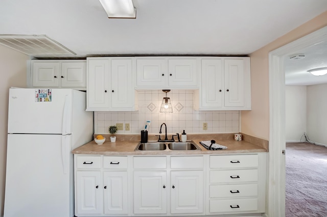 1036 State Route 247, Hillsboro, OH 45133 - kitchen featuring freestanding refrigerator, white cabinetry, tasteful backsplash, light countertops, and carpet flooring