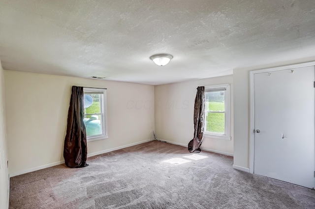1036 State Route 247, Hillsboro, OH 45133 - spare room with healthy amount of natural light, carpet floors, and a textured ceiling