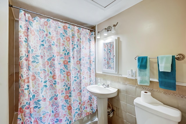 1036 State Route 247, Hillsboro, OH 45133 - full bathroom featuring a shower with curtain, tile walls, and wainscoting
