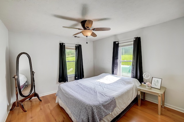 1036 State Route 247, Hillsboro, OH 45133 - bedroom with multiple windows, light wood-style floors, and ceiling fan