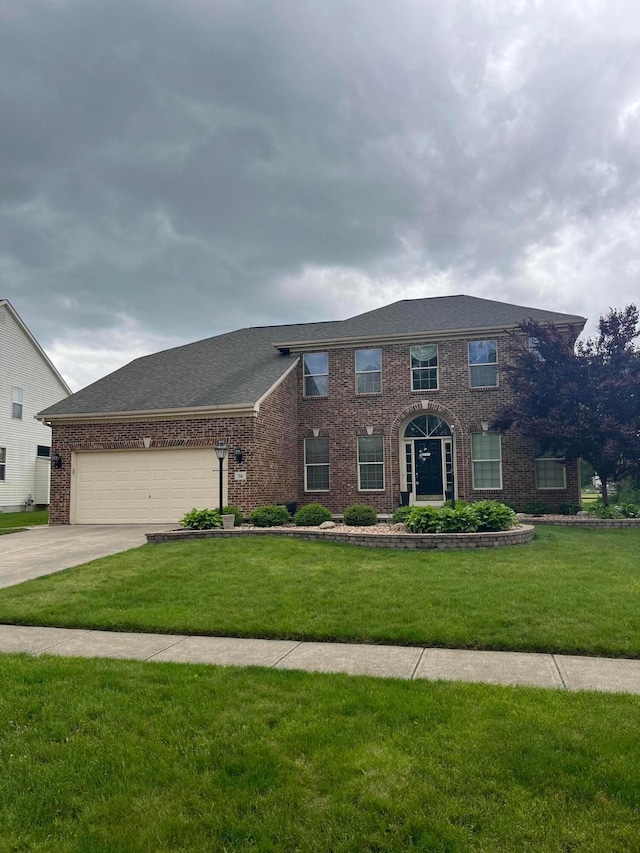 56 Dellenbaugh Loop, Etna, OH 43062 - colonial home featuring brick siding, a front yard, a garage, and concrete driveway