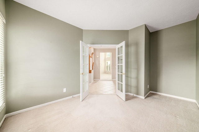 56 Dellenbaugh Loop, Etna, OH 43062 - empty room featuring french doors, light carpet, and baseboards