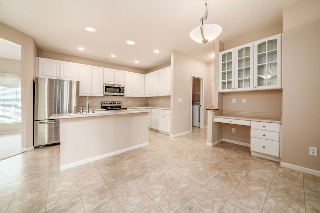 56 Dellenbaugh Loop, Etna, OH 43062 - kitchen with stainless steel appliances, washer / clothes dryer, white cabinetry, glass insert cabinets, and recessed lighting