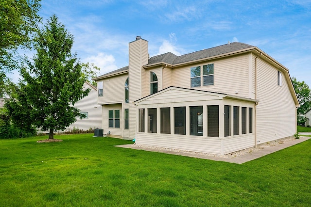 56 Dellenbaugh Loop, Etna, OH 43062 - rear view of property featuring a chimney, a sunroom, a yard, and central AC unit