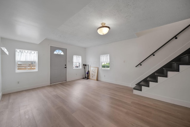 173 Highland Ave, Buckeye Lake, OH 43008 - foyer featuring wood finished floors, stairs, baseboards, and a textured ceiling