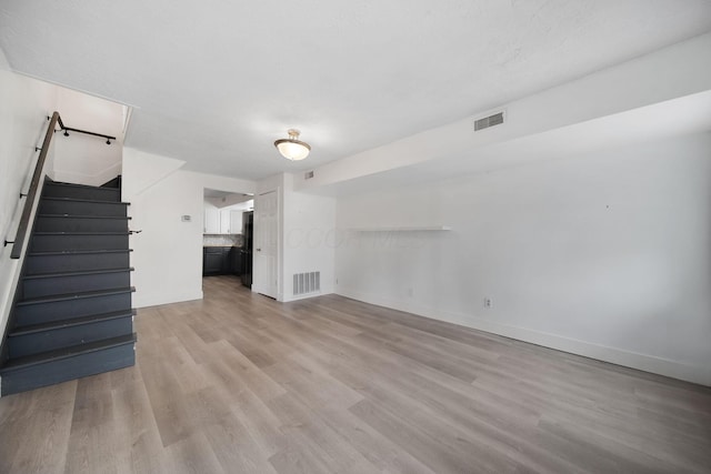 173 Highland Ave, Buckeye Lake, OH 43008 - unfurnished living room featuring light wood-style flooring, baseboards, and stairs