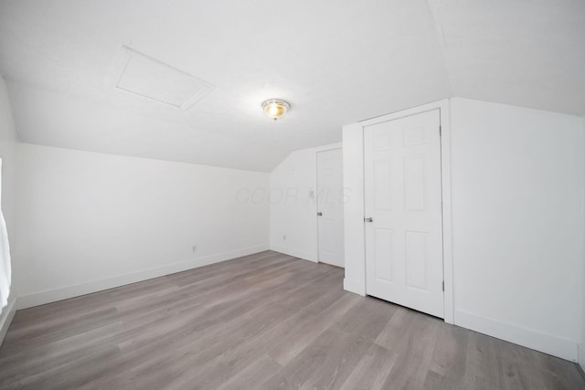 173 Highland Ave, Buckeye Lake, OH 43008 - additional living space featuring attic access, lofted ceiling, wood finished floors, and baseboards