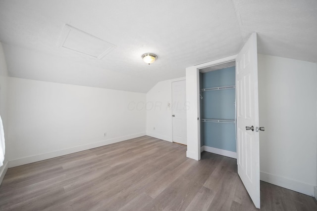 173 Highland Ave, Buckeye Lake, OH 43008 - bonus room with attic access, lofted ceiling, wood finished floors, and baseboards