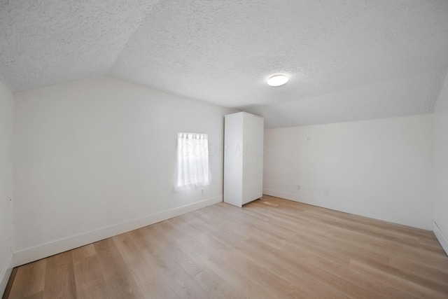 173 Highland Ave, Buckeye Lake, OH 43008 - bonus room featuring vaulted ceiling, a textured ceiling, light wood finished floors, and baseboards