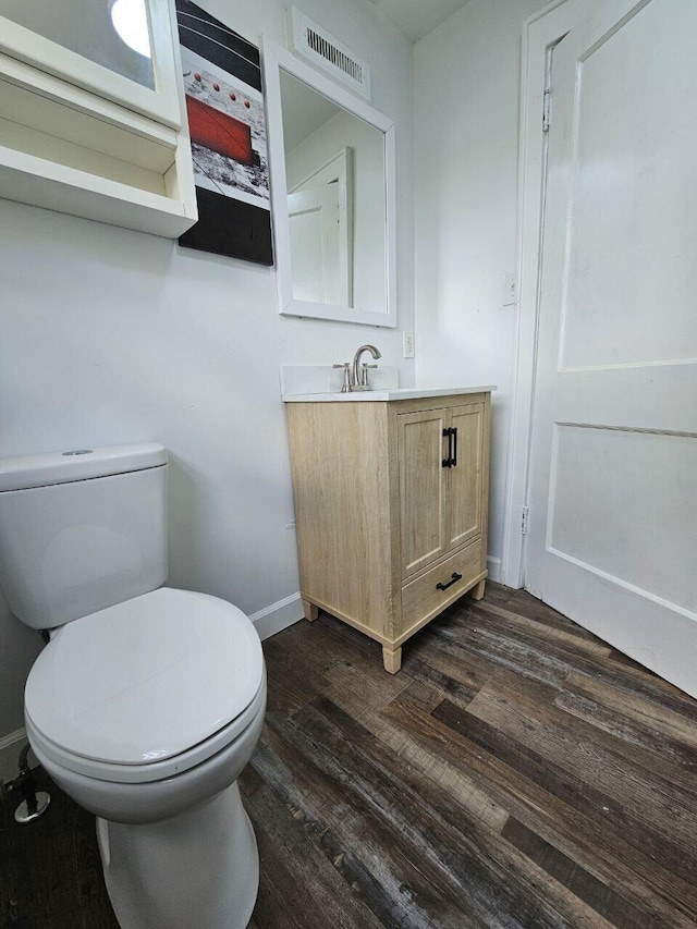 2889 E 12th Ave, Columbus, OH 43219 - bathroom with toilet, baseboards, vanity, and wood finished floors