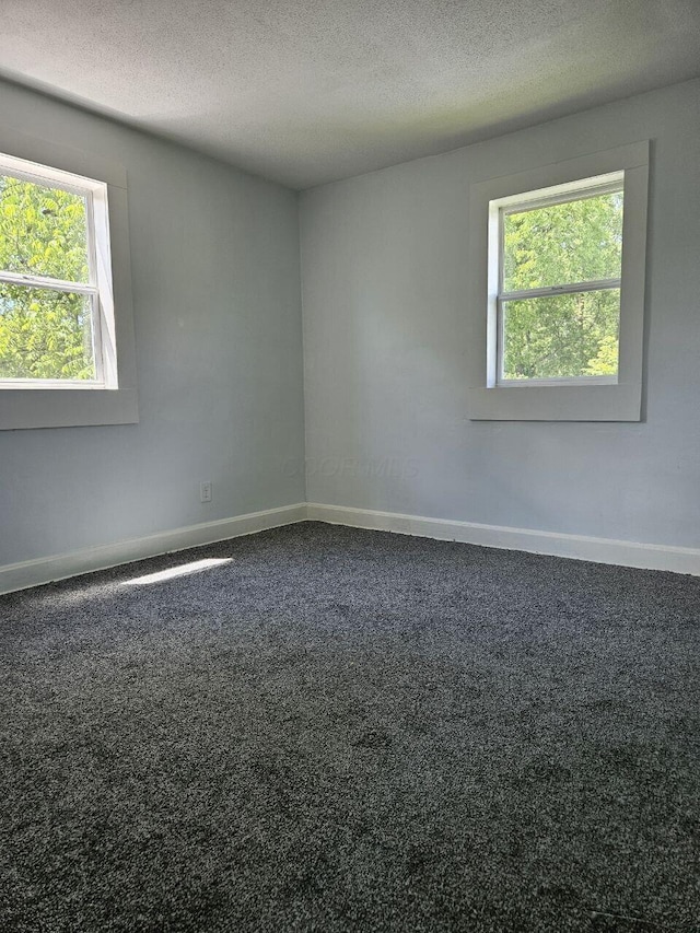 2889 E 12th Ave, Columbus, OH 43219 - empty room featuring baseboards, a textured ceiling, and carpet floors