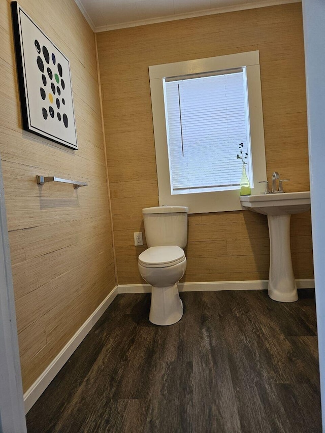 2889 E 12th Ave, Columbus, OH 43219 - bathroom featuring toilet, ornamental molding, wood finished floors, baseboards, and wood walls