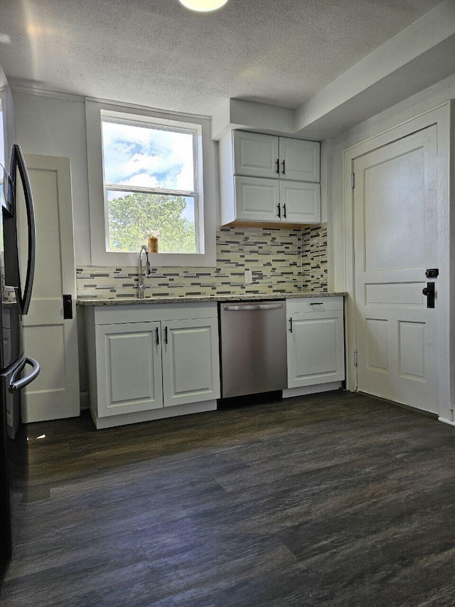 2889 E 12th Ave, Columbus, OH 43219 - kitchen featuring stainless steel dishwasher, a sink, white cabinets, freestanding refrigerator, and a textured ceiling