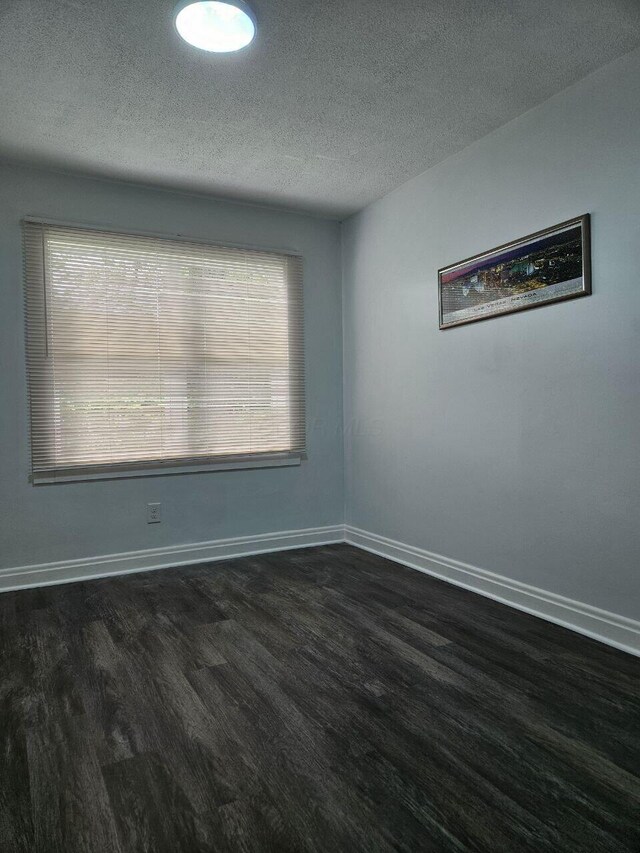 2889 E 12th Ave, Columbus, OH 43219 - spare room with wood finished floors, a textured ceiling, and baseboards